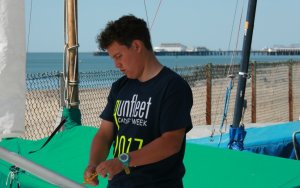 Cadet Commodore Harry Swinbourne rigging his boat ready for racing at Gunfleet