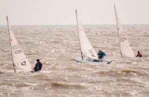 Lively conditions surround the top three sailors in the race for the Toppo Trophy. From left to right - Rob Lockett, Andy Dunnett, and Ken Potts