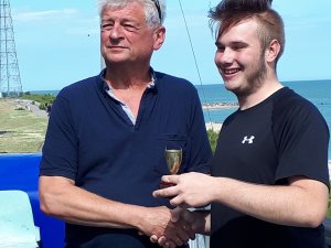Gunfleet Cadet Michael Gutteridge is presented with the Clacton Sailing Club Regatta CUDC Cadet Cup by CSC Commodore Martin Chivers