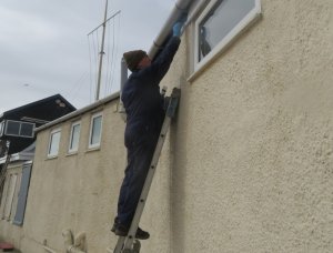 Roy up the ladder with the paint