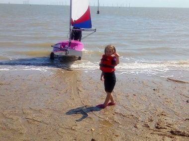 Five year old Belle gives the thumbs-up as Cadet Commodore Harry launches her Topper "Ding Dong"