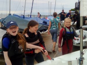 Take three girls - Lily Kearns-Kennedy, Millie Berry and Hannah Aylen wash their Topaz down after some fun on the water during sail training