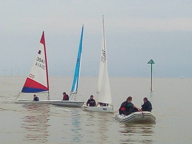 Some of the dinghies being towed back after being becalmed