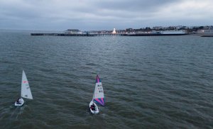 Darkness starts to fall as the dinghies head towards Clacton Pier