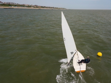 Rob Lockett crosses the finishing line in his Laser