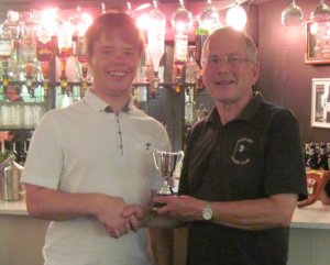 Robert Gutteridge receives the Cadet Trophy for winning yesterday's race in his Laser