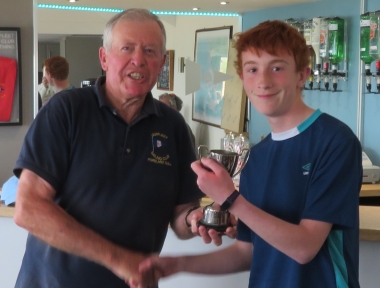 Malcom Jolly presents Finley Taylor with the Mad Hatters Cup for winning the afternoon Topper race