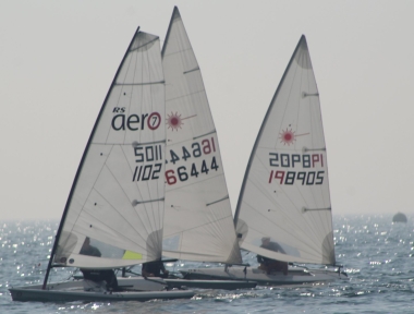 Jono Dunnett's Laser being sandwiched between John Tappenden's RS Aero and Brian Allen's Laser