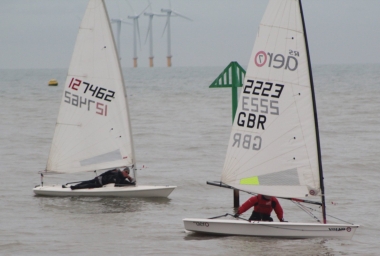 Dave Ingle tacks his RS Aero to try and round the IDM, whilst Robert Mitchell's Laser crosses the line very slowly