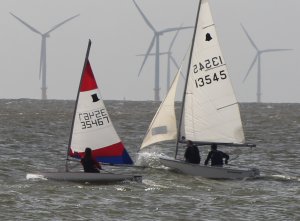 Belle Hart, in her Topper, holds off the GP14 as they race to the first mark