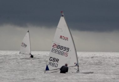 Tim Dye leads his Laser, with Robert Mitchell in the background