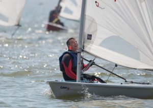 Ken Potts glances pleasingly at his sail shape before winning the Wallet Trophy