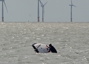 Dale Steggles rights his Laser after a capsize