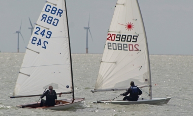 Ken Potts leads the way in his Laser, with Simon Clarke just behind him in his Europe