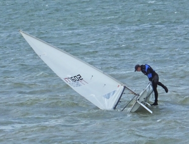 Adam Kedge rights his Laser, following a capsize