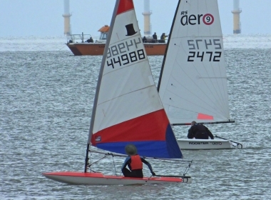 Brian Allen in his RS Aero 9 passes Finley Taylor in his Topper as they both make the most of the very light breeze