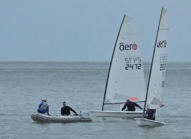 The Club's Safety Boat keeps an eye on two RS Aero 9's as they head towards the start line