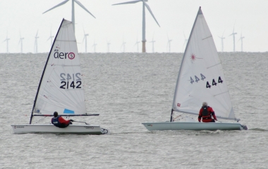 Ken Potts sails past Andy Dunnett's Laser in his RS Aero, early on in the race