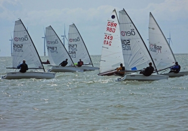 Adam Kedge, in his Laser, leads the fleet in the second race