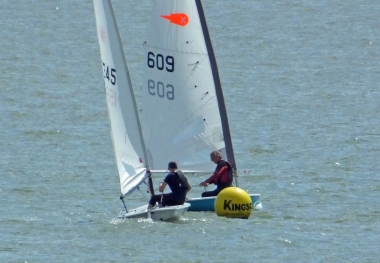 Peter Downer, in his Comet, holds off Adam Kedge's Laser at the first mark