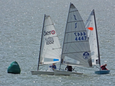 A meeting of dinghy classes as they round AWS