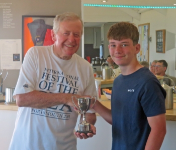 Charlie Heath is presented with the Mad Hatters Cup