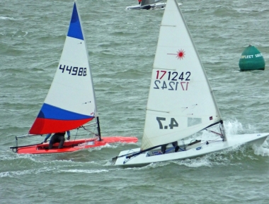 Finley Taylor in his Topper, and Yvonne Gough in her Laser, have a flying start