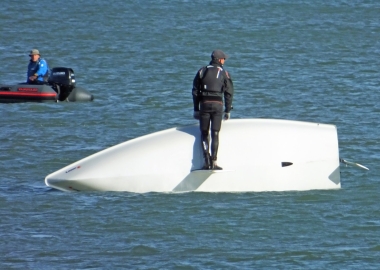 Adam Kedge capsized, under the watchful eye of the Club's Safety Boat