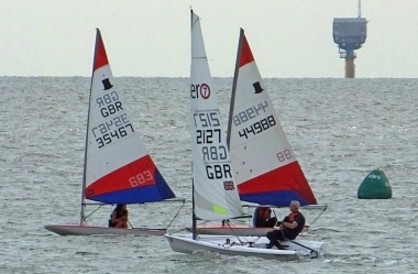 Tim Dye, in his RS Aero, passes Belle Hart and Finley Taylor in their Toppers