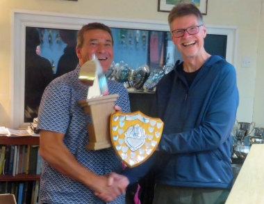 Sailing Secretary Chris Maloney presents Ken Potts with two of his many trophies