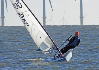 Brian Allen catches a gust in his RS Aero, sailing under the shadow of the Gunfleet Wind Farm