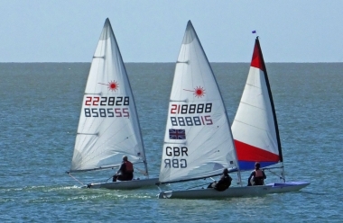 Adam Kedge and Paul Stanton, in their Lasers, sandwich Debbie Chivers' Topper