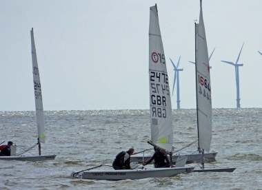 Jono Dunnett in his Laser slips past Brian Allen in his RS Aero