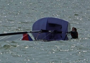 Debbie capsizes before the Topper start but keeps her hair dry!