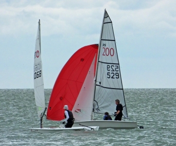 John and Charlie Heath fly the gennaker on their RS200 as they slip past Paul Jackson in his RS Aero
