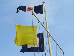 The signal flags fly briskly in the force 3 to 4 East/South-Easterly
