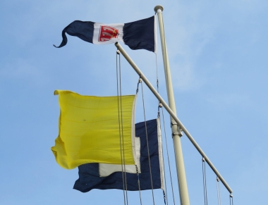 The signal flags fly briskly in the force 3 to 4 East/South-Easterly