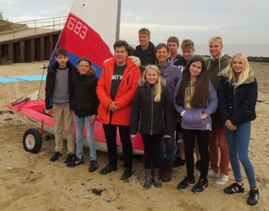 Cadet Commodore Harry Swinbourne, in the orange Parker, with the Cadet Officer Claire Aylen on his left, and a few of the Gunfleet Cadets and Otters, stand proudly by their new Club Topper; funded by the very generous grant of the John Merrick Sailing Trust