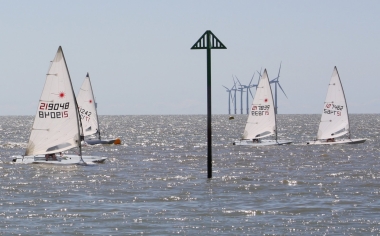 The start of the Fleet Championship race with Robert Mitchell leading, followed by Andy Dunnett, both in Lasers