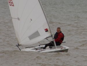 Brian Allen, having just righted his Laser, gives chase to the rest of the fleet