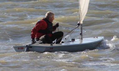 Brian Allen leading the fleet in his Laser at the end of the first lap