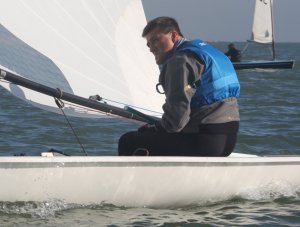 Winning sailor Ken Potts taking his Laser to victory