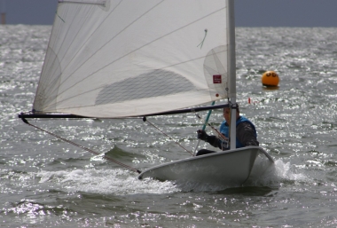 The donor of the race trophy, Ken Potts, takes his Laser to a convincing win