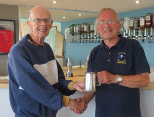 Winner of the Comet Class Keith Lamdin receives his trophy