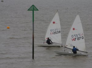 With rather more bend in the mast than usual, Robert Mitchell leads Ken Potts at the start of the race for the Tee Dee Trophy