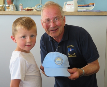 Four year old Albert Mosey collects his prize for the picture of a Lifeboat he coloured