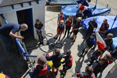 The Gold Squad gather around the Course Chart as the Commodore explains where everyone should go