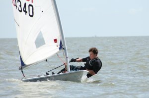 Cadet Commodore Harry pushes his Laser into the lead position