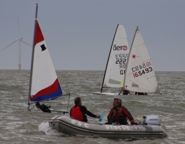 Adam Kedge in his Topper, hidden by the waves, puts in a quick tack at the start