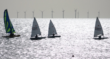 The start of the race and the leading competitors are silhouetted in the low sunshine